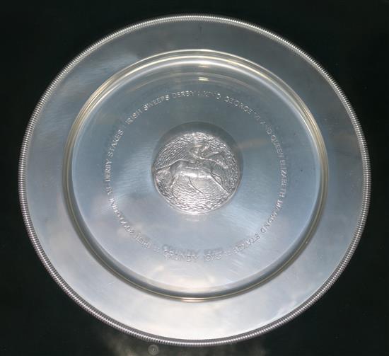 A framed silver commemorative dish relating to Grundy champion racehorse by Stuart Devlin